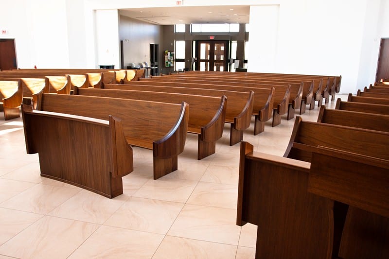 Mahogany wood pews from left