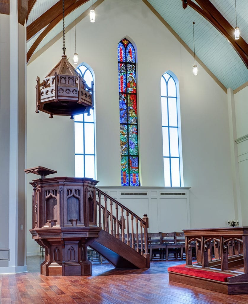 pulpit with stained glass in background