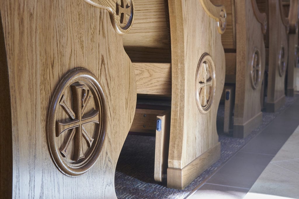 intricate carving on pew ends