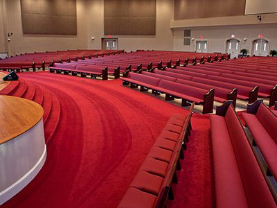 Red church pews create a sense of tradition in a church.