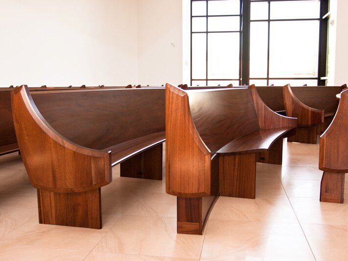 Modern church pews provide a designated space for wheelchair access