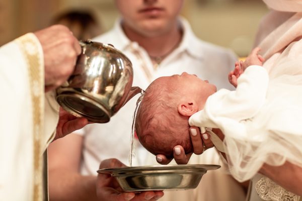 A baby being baptized at a Catholic church.