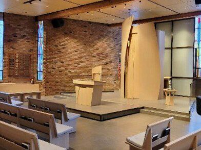 A view of a synagogue with contemporary-style pews